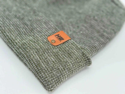 Gray-green knit beanie cuff detail with orange logo label