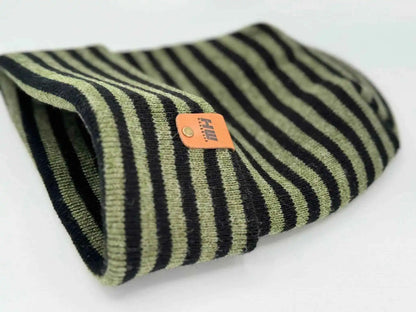 Cuffed knit beanie with black, green, and cream stripes; orange brand label