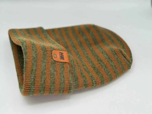 Brown and green striped cuffed beanie with leather patch, folded side view