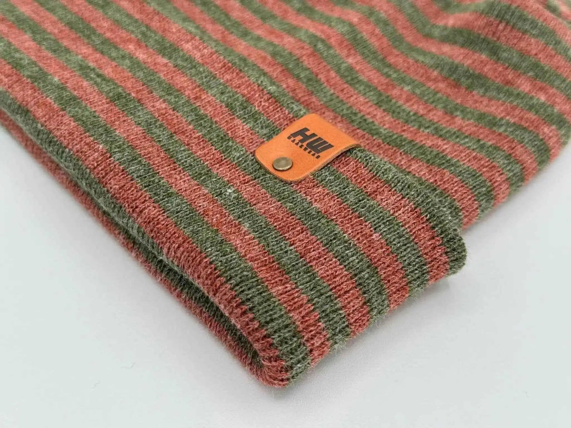 Striped knit beanie cuff with orange brand tag patch, burgundy and green