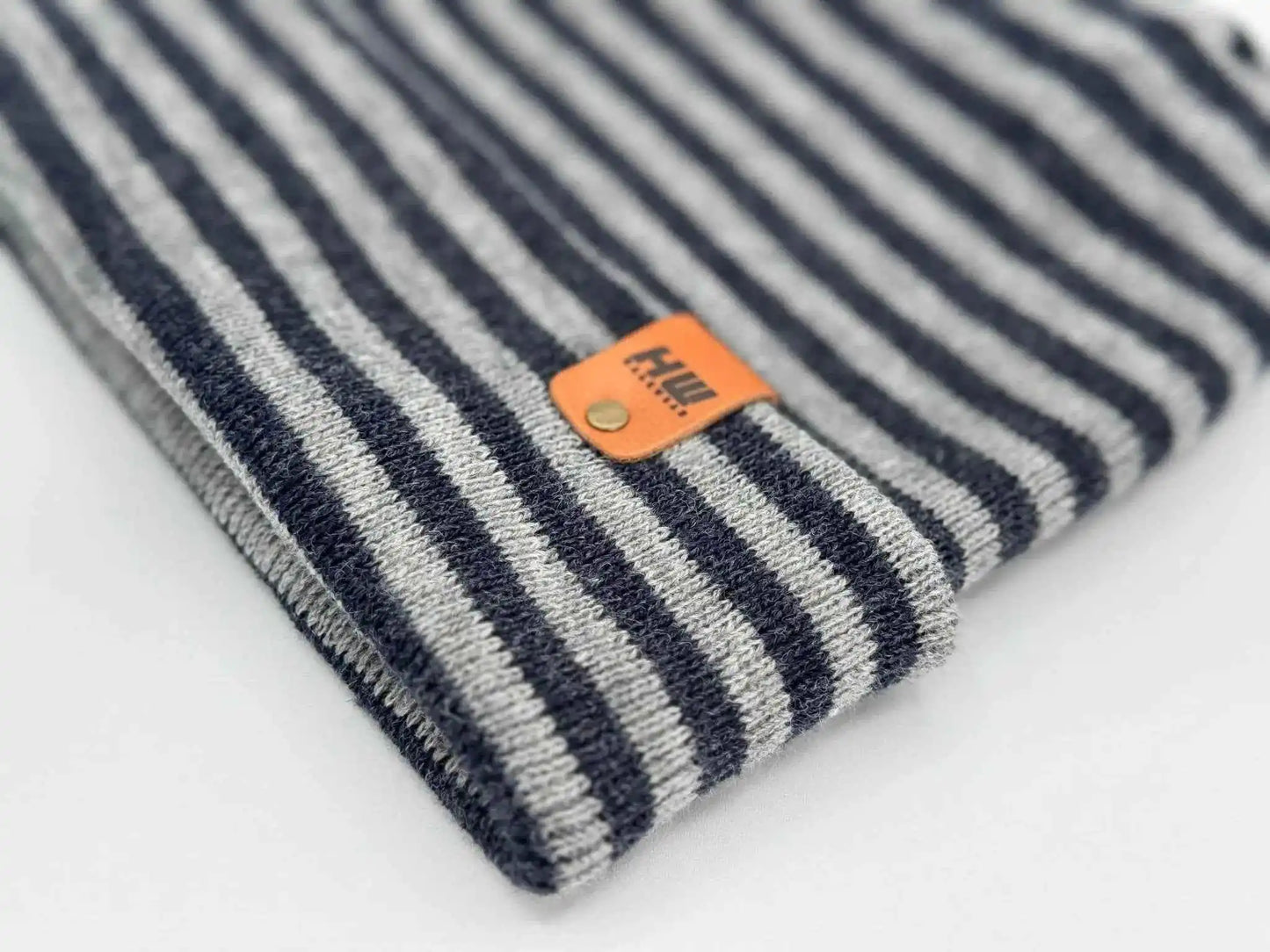 Striped cuffed beanie with orange logo patch on knit cuff