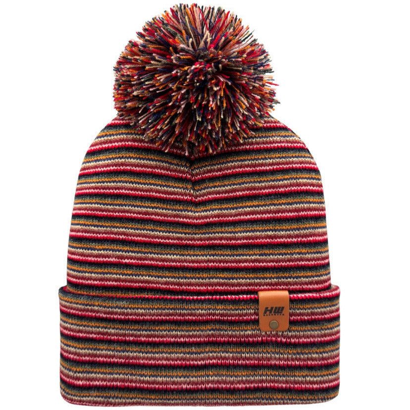 Multicolored striped beanie with a pom-pom on a white background