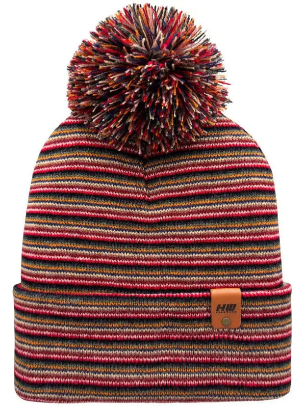 Multi-color striped knit beanie with ribbed cuff and large pom-pom