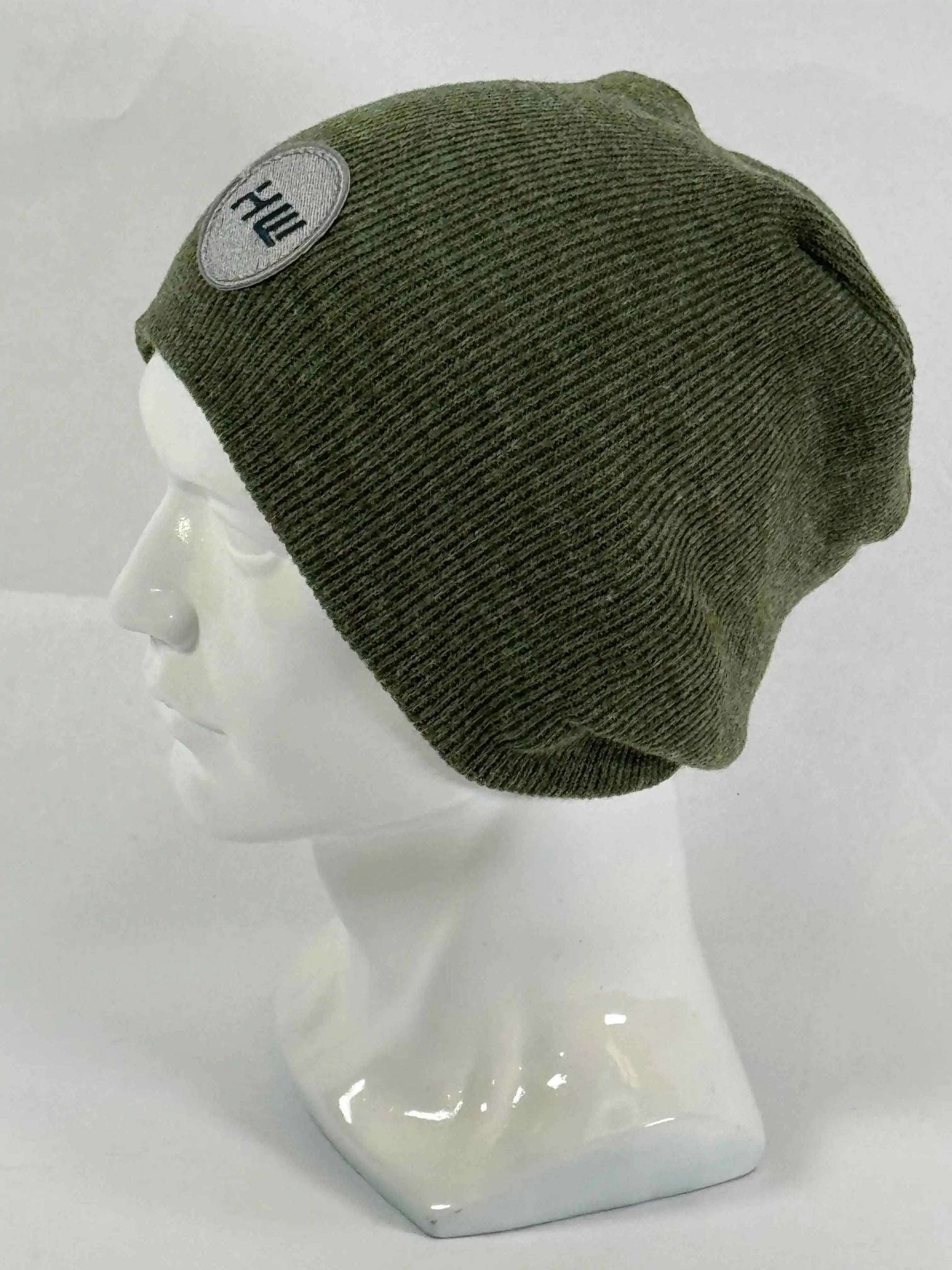 Olive green knit beanie with un-cuffed ribbed edge and small HUI logo label.