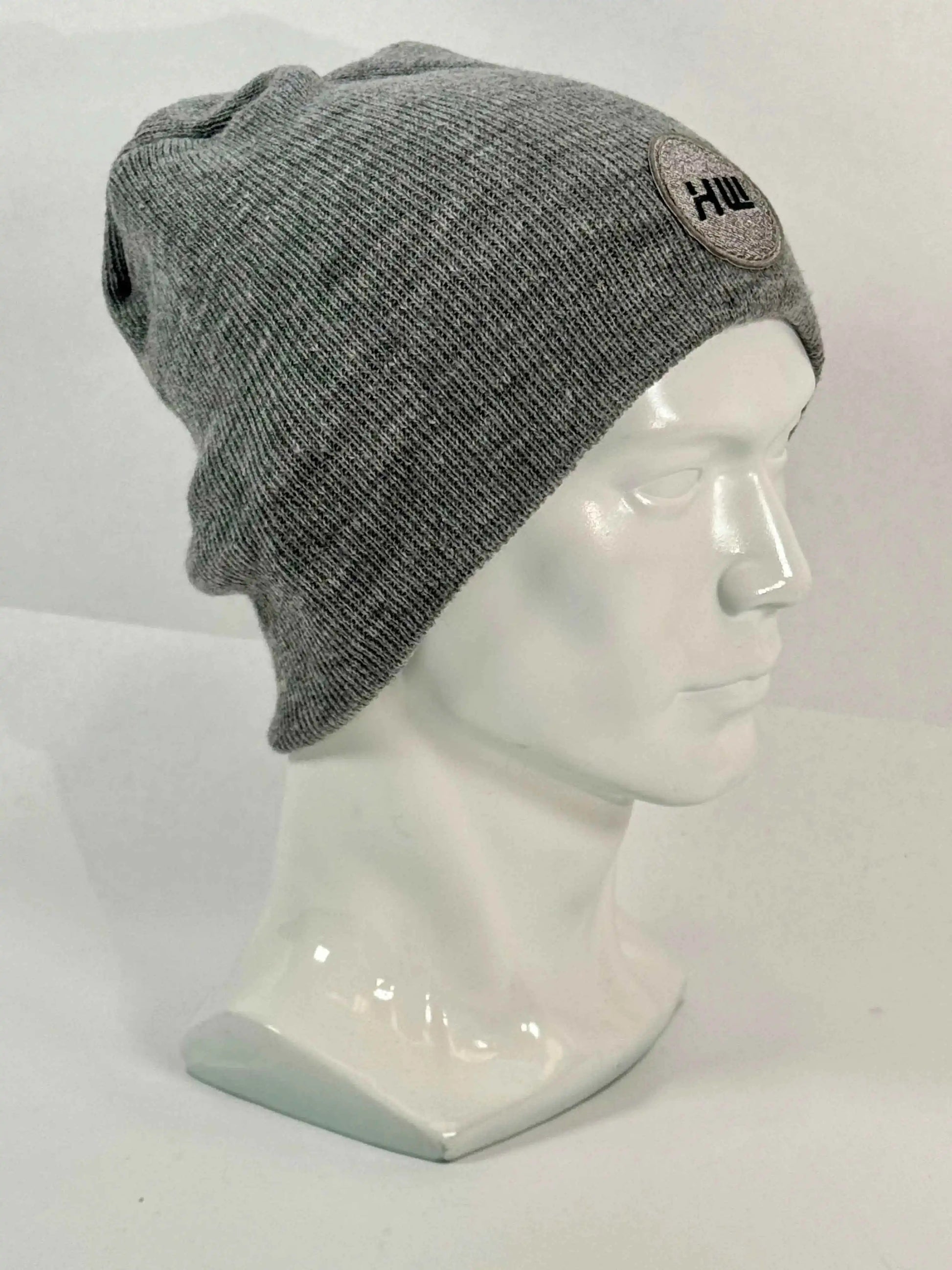 Gray knit beanie, uncuffed fit, ribbed texture and side round logo patch