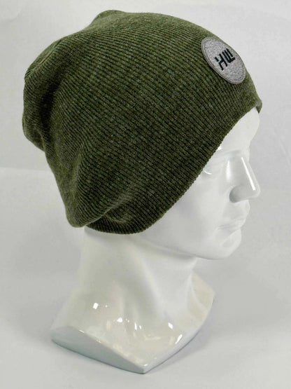 Olive green knit beanie with un-cuffed rolled edge and round HUI logo patch.
