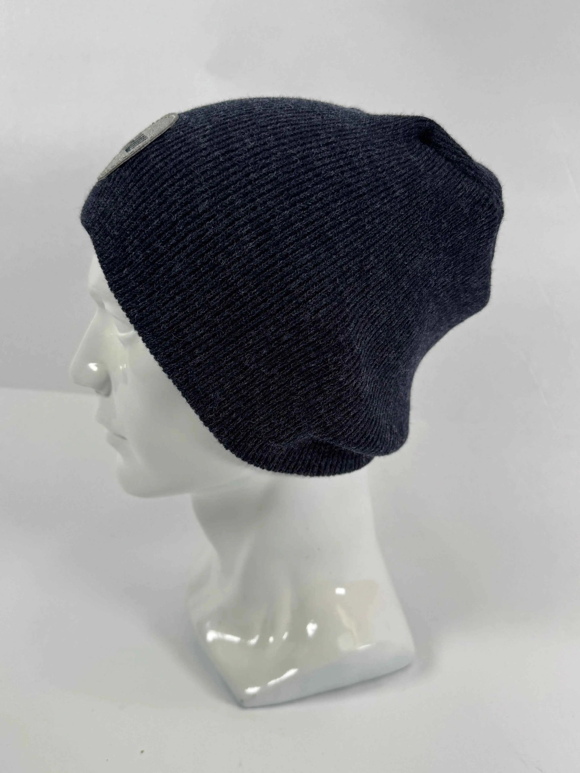 Navy knit beanie with un-cuffed ribbed edge and small HUI logo label on side.