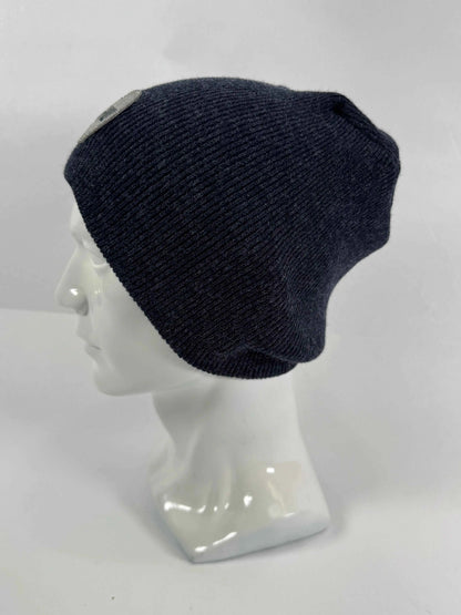 Navy knit beanie with un-cuffed ribbed edge and small HUI logo label on side.
