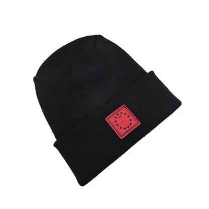 Black knit beanie with folded cuff and small square pink heart clock patch