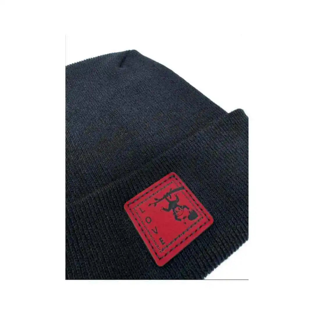 Black knit beanie with red square love monkey tag on folded brim