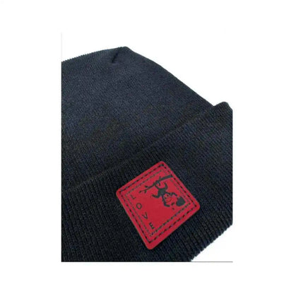 Black knit beanie with red square love monkey tag on folded brim