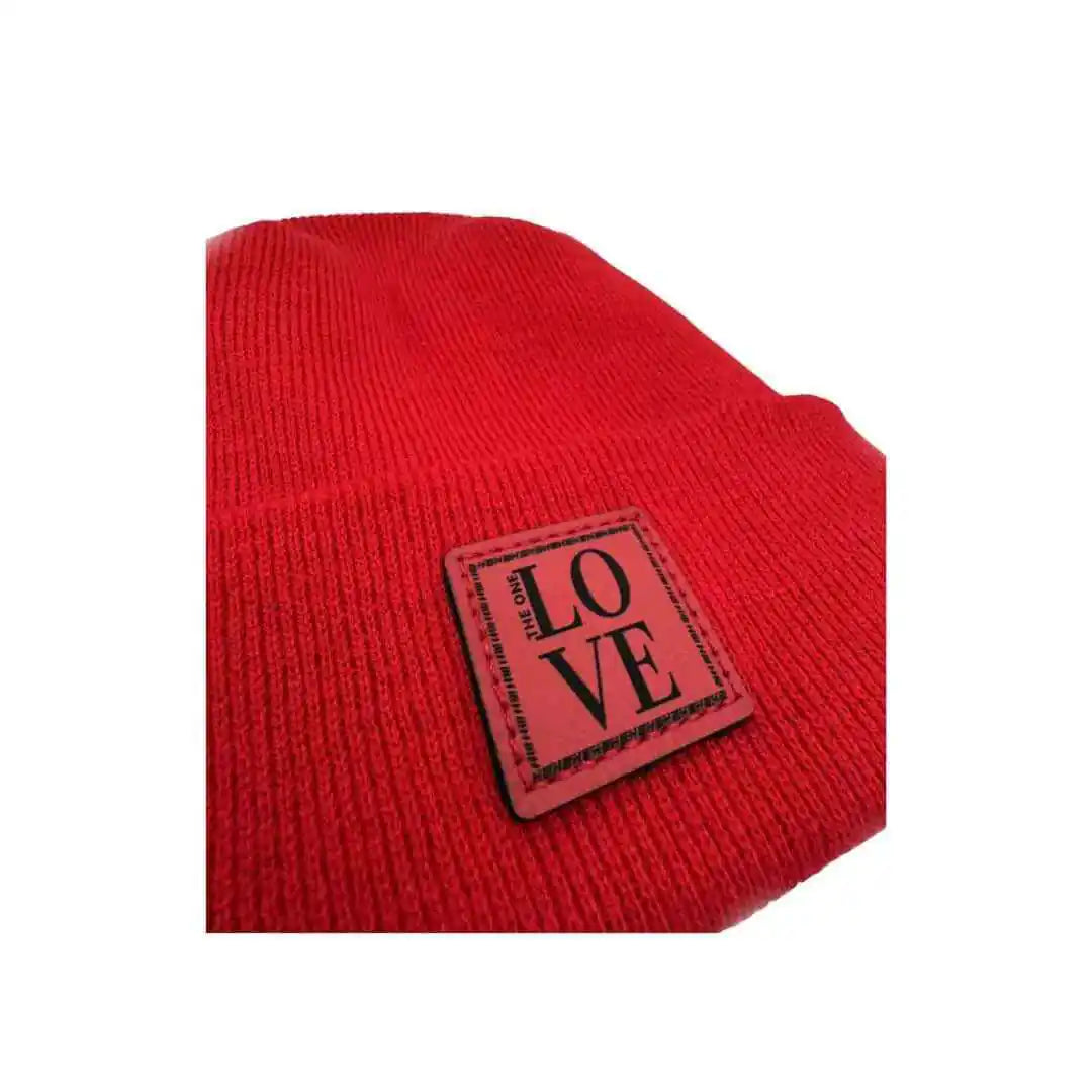 Red knit beanie close-up with LOVE logo patch on cuff