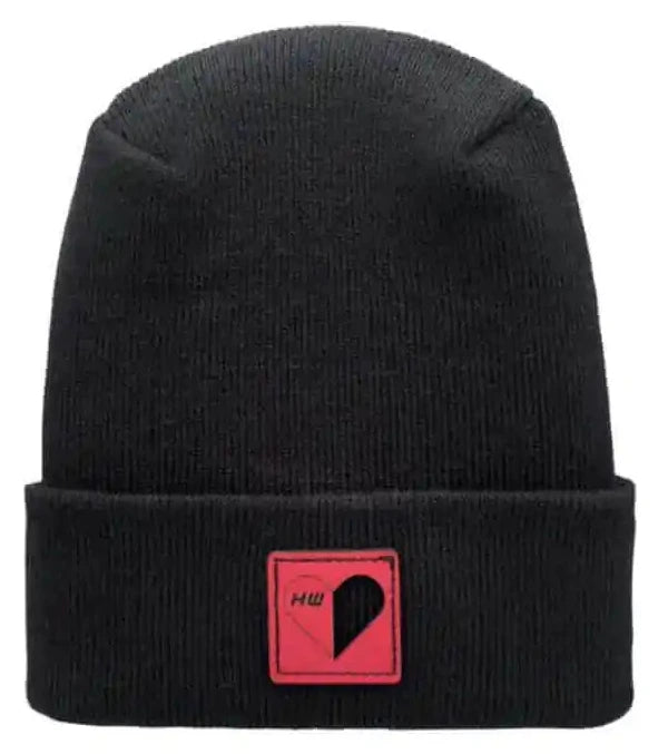 Black knit beanie with heart-shaped patch on cuff