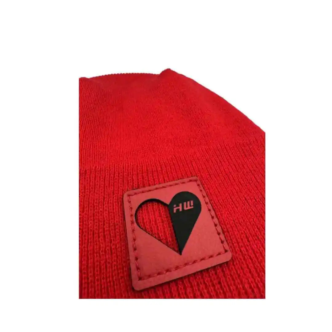 Scarlet red knit beanie showing heart logo patch detail