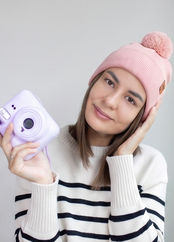Pearl pink ribbed knit beanie with folded cuff and fluffy pom pom topper