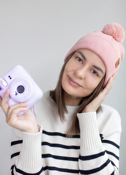 Pearl pink ribbed knit beanie with folded cuff and fluffy pom pom topper